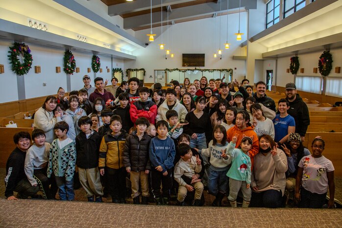 Children from the Biko-en Orphanage pose for a group photo at Misawa Air Base, Japan, Dec. 21, 2024.