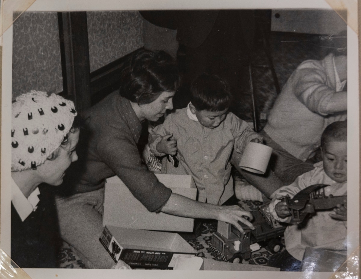 A volunteer of the Officer Wife Club presents gifts to children at the Biko-en Orphanage in Shichinohe, Japan, Dec. 1967.