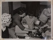 A volunteer of the Officer Wife Club presents gifts to children at the Biko-en Orphanage in Shichinohe, Japan, Dec. 1967.
