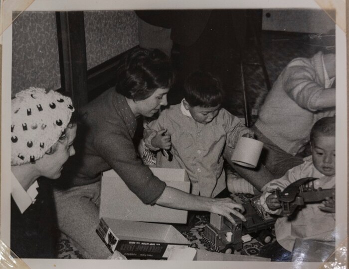 A volunteer of the Officer Wife Club presents gifts to children at the Biko-en Orphanage in Shichinohe, Japan, Dec. 1967.