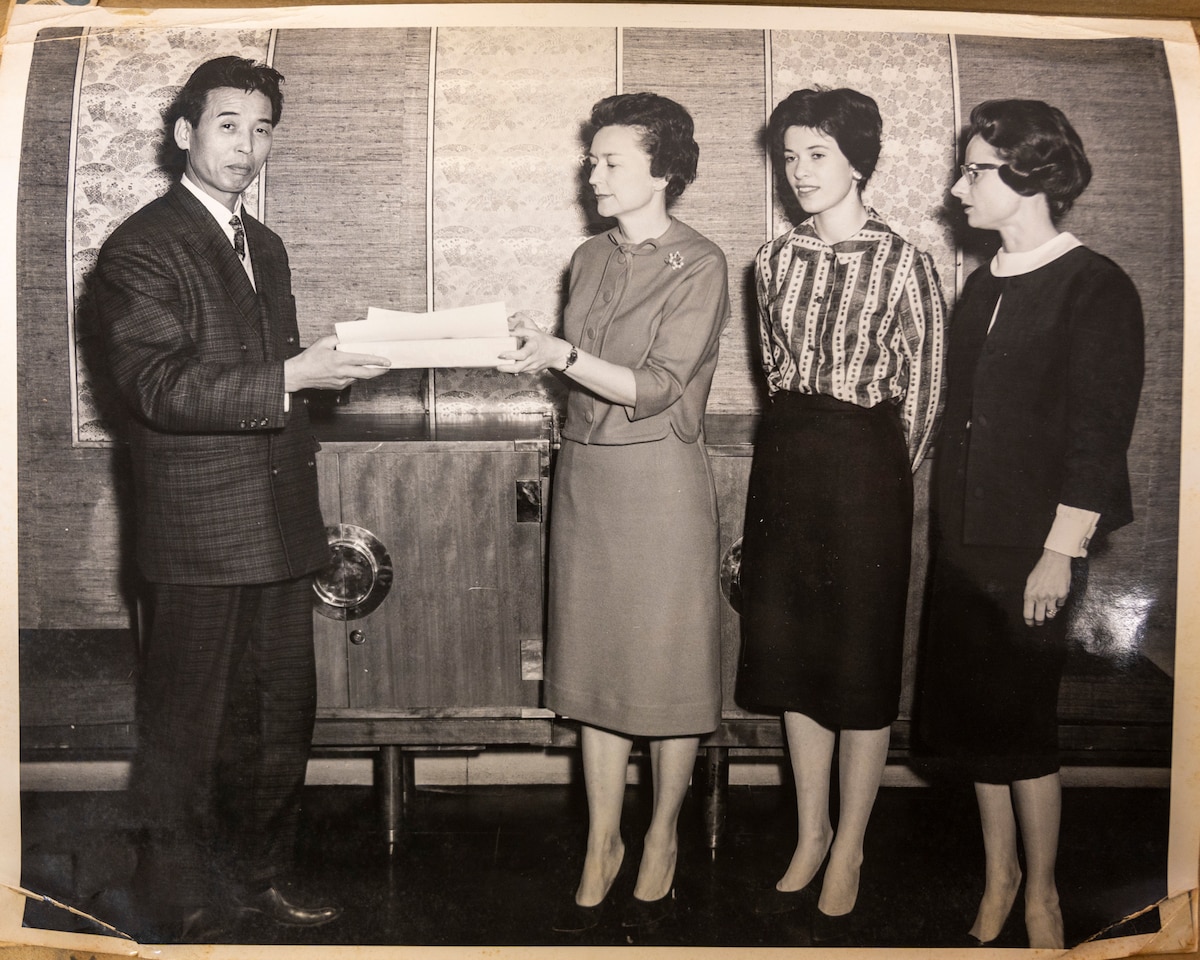 A volunteer of the Officer Wife Club is presented a certificate of appreciation at the Biko-en Orphanage in Shichinohe, Japan, Dec. 1967.