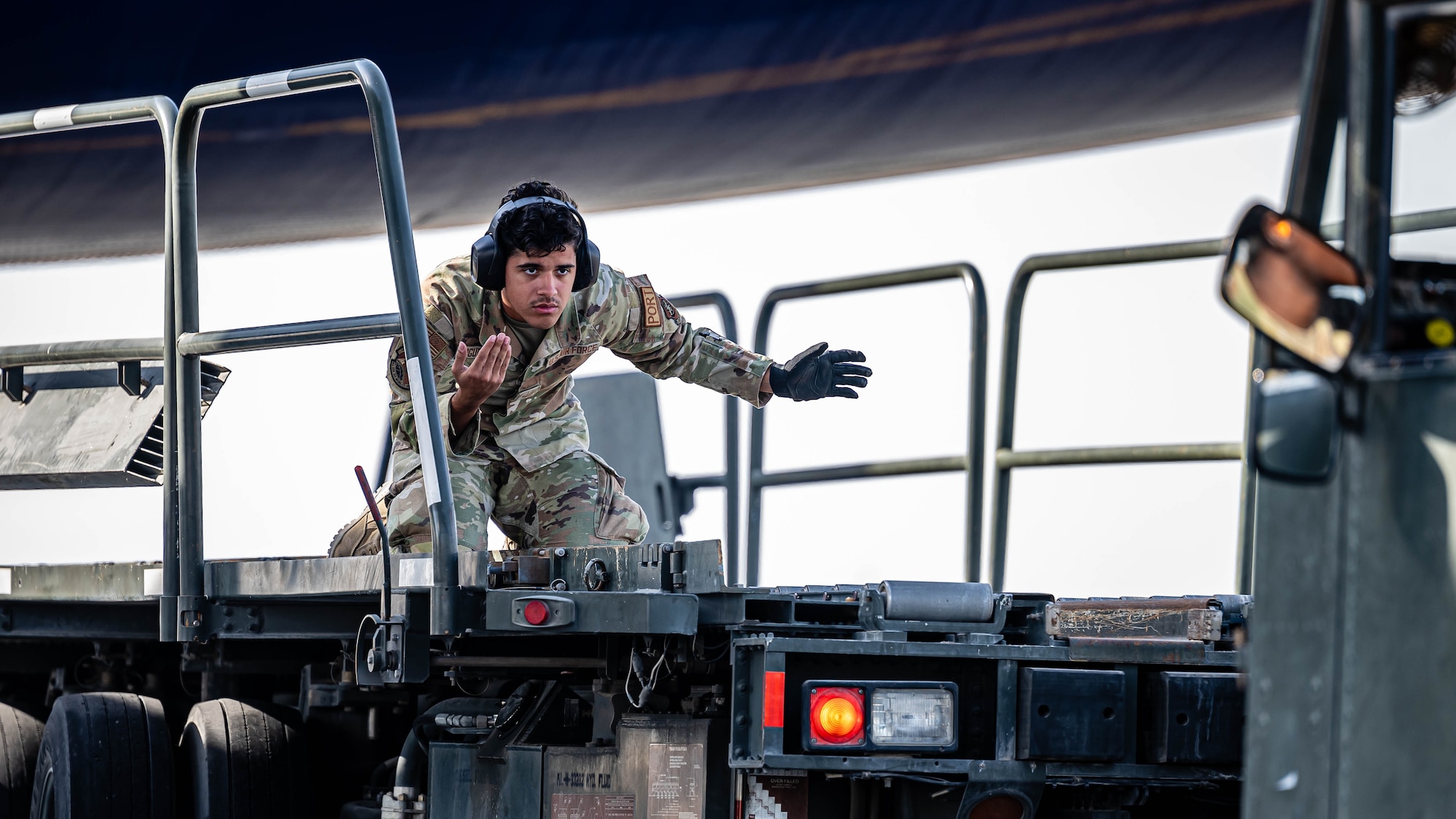 Airman directs cargo loader.