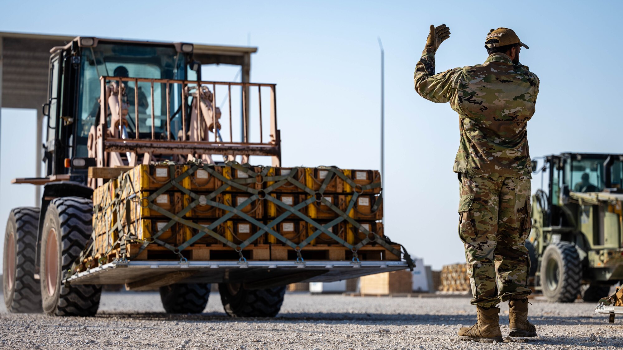 Airmen build pallets.