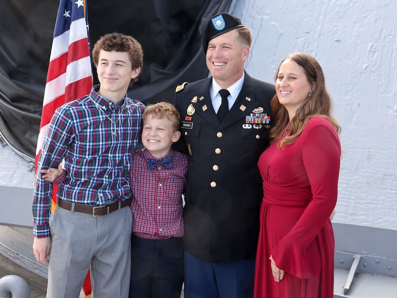 Picture of a family in front of a flag