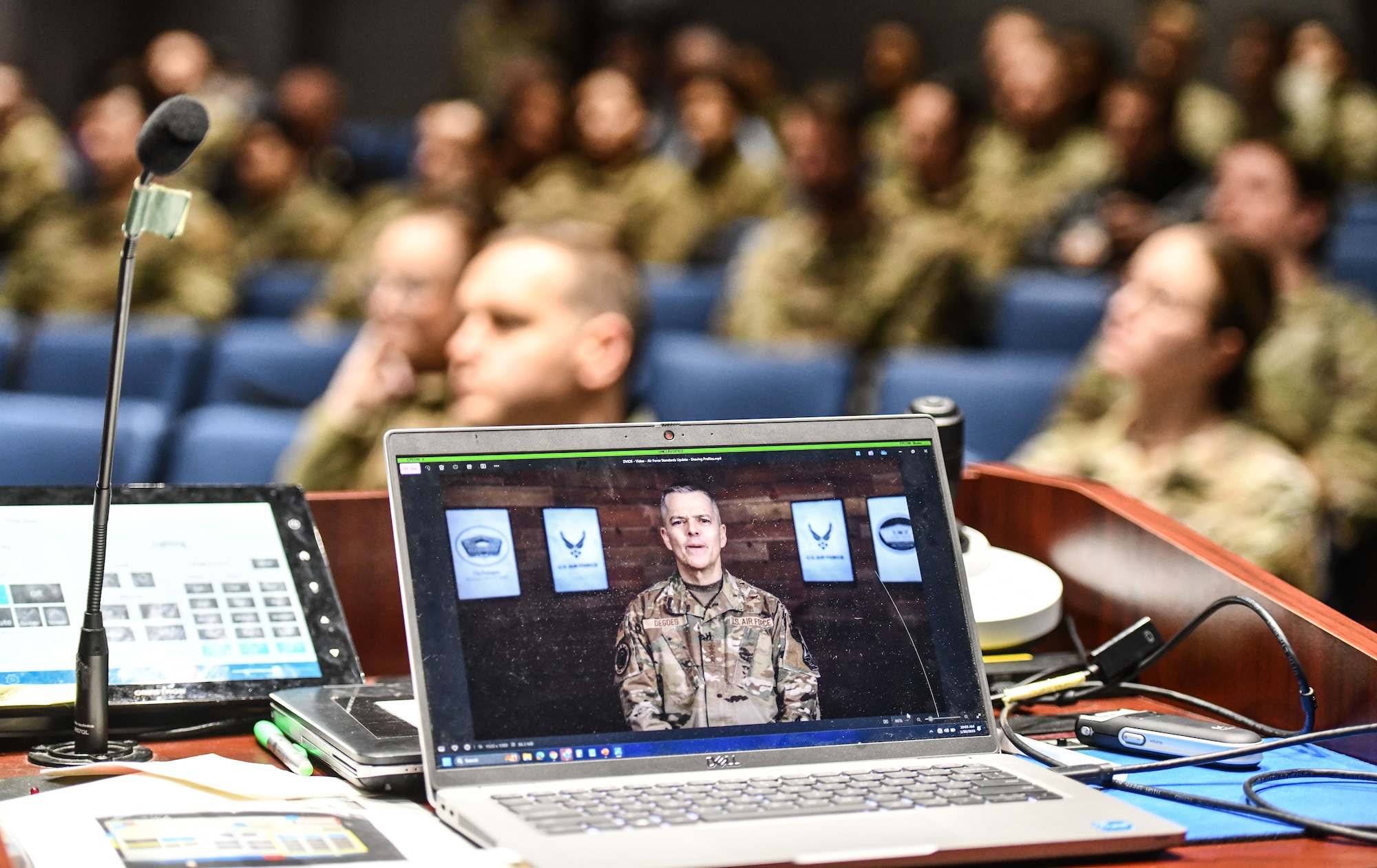 Airmen watch a video of Lt. Gen. John Degoes, Air Force Surgeon General, at the Urschler Theater on Offutt Air Force Base, Jan. 30, 2024. In a series of all calls, senior leaders met face-to-face with personnel to address key policy changes and provide an open forum for discussion. (U.S. Air Force photo by Chad Watkins)