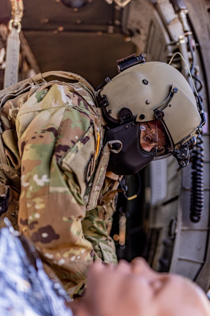 Staff Sgt. Tony McCall, detachment noncommissioned officer-in-charge for Detachment 1, Charlie Company, 1st Battalion, 169th Aviation Regiment, Oklahoma Army National Guard, secures a medical evacuation (MEDEVAC) dummy during a joint training exercise at the Glenwood Training Area in Oklahoma City, Jan. 28, 2025. During the exercise, combat medics from the 72nd Air Base Wing, Tinker Air Force Base, practiced patient stabilization, MEDEVAC calls and loading procedures while coordinating closely with the OKARNG pilots conducting helicopter insertions in austere environments. (Oklahoma National Guard photo by Sgt. Haden Tolbert)