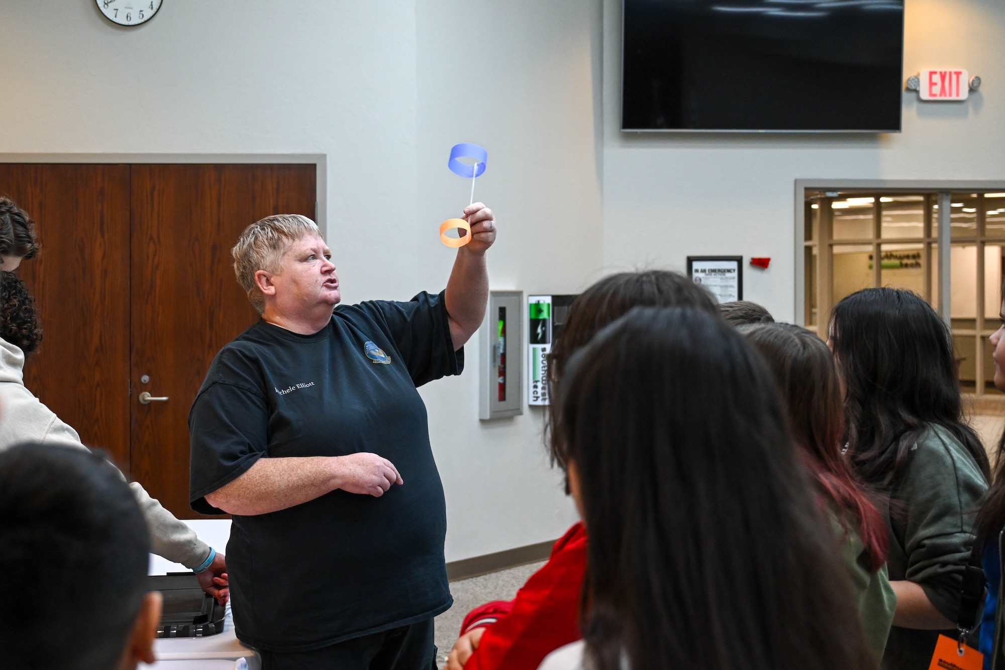 Michelle Elliot, 97th Maintenance Squadron avionics technician, showcases a glider to students during a Science, Technology, Engineering, Arts, and Mathematics fair at Southwest Technology Center at Altus, Oklahoma, Jan. 22, 2025. Elliot taught the children how to build a glider to demonstrate the principles of how aircraft stay in the air. (U.S. Air Force photo by Airman 1st Class Lauren Torres)