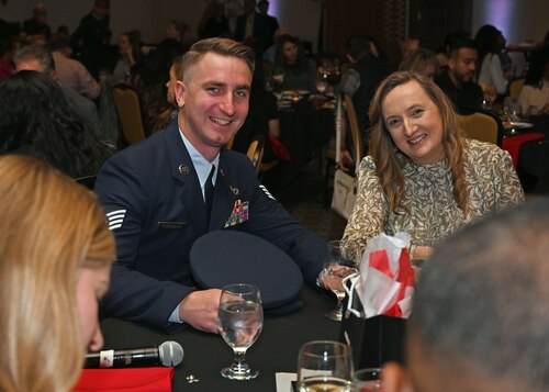 U.S. Air Force Staff Sgt. Christopher Rickenbach, 355th Civil Engineer Squadron firefighter, left, and his mother, right, attend a ceremony in Oro Valley, Arizona, Feb. 4, 2025. At the ceremony, Rickenbach was awarded the Red Cross Certificate of Merit for administering life-saving actions. (U.S. Air Force photo by Staff Sgt. Abbey Rieves)