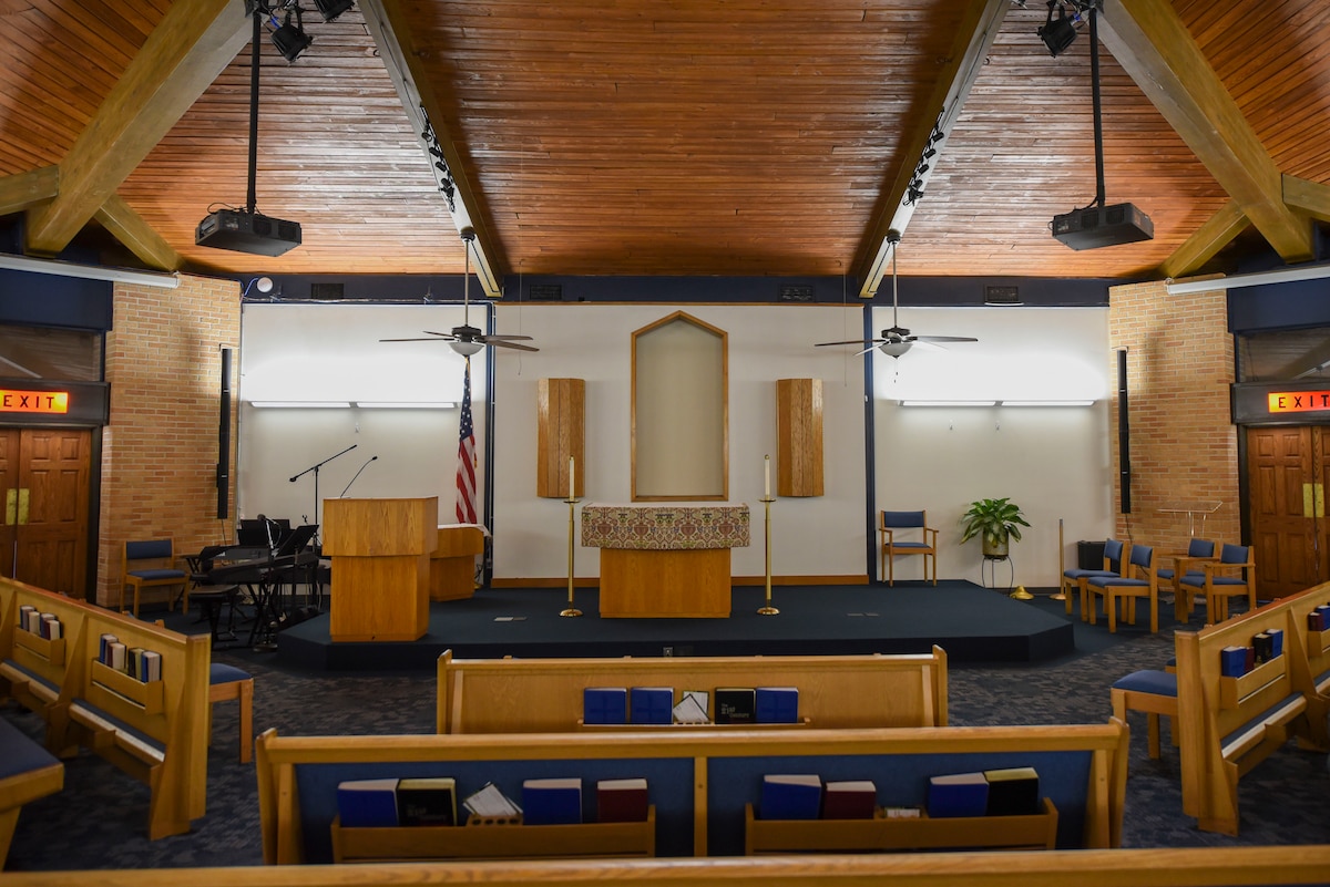 Pews facing the front podium of the Prairies Chapel