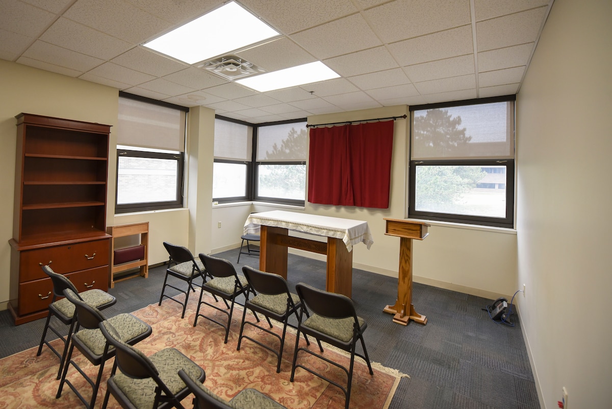 A set of chairs face a podium inside the AFIT building
