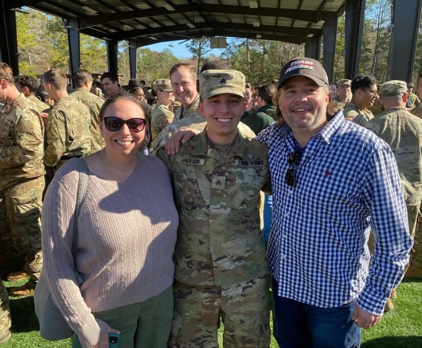 Sgt. Benjamin Jackson, a biomedical equipment specialist at the U.S. Army Medical Materiel Center-Europe, is pictured with his parents Dec. 20, 2024, at Fort Moore, Georgia, following a pinning ceremony as he received the Expert Field Medical Badge, a prestigious recognition for Army medical personnel.