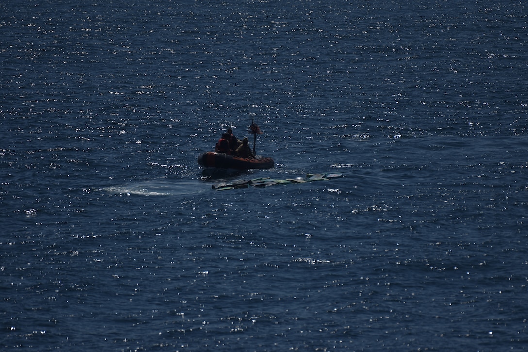 A small boat crew from USCGC Campbell (WMEC 909) approaches bales of jettisoned cocaine after go-fast vessels fled the area in the Eastern Pacific Ocean, Dec. 30, 2024. The small boat crew recovered 39 bales weighing approximately 4,044 pounds with an estimated street value of more than $45.8 million. (U.S. Coast Guard photo)