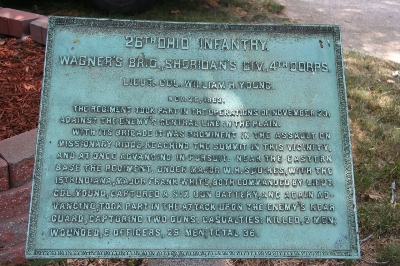 A bronze marker with raised text.
