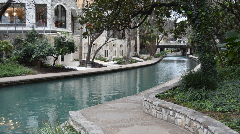 A city river with side walks on either side and with buildings along the path