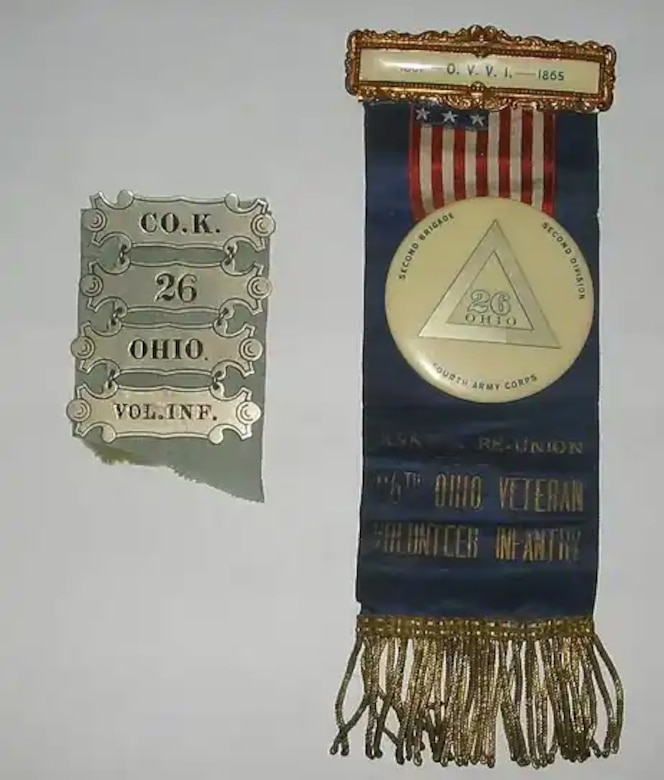 A badge and ribbon with gold fringe.