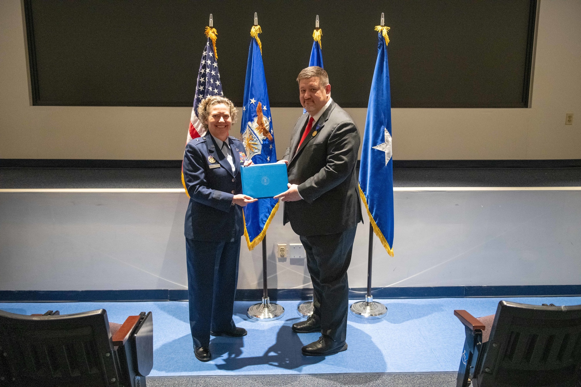 U.S. Air Force Brig. Gen. Amy Bumgarner, AFOSI Commander, presents the Air Force Decoration for Exceptional Civilian Service to special agent John Nick at Joint Base Anacostia-Bolling, Jan. 24, 2025. (U.S. Air Force photo by Trevor Saylor)
