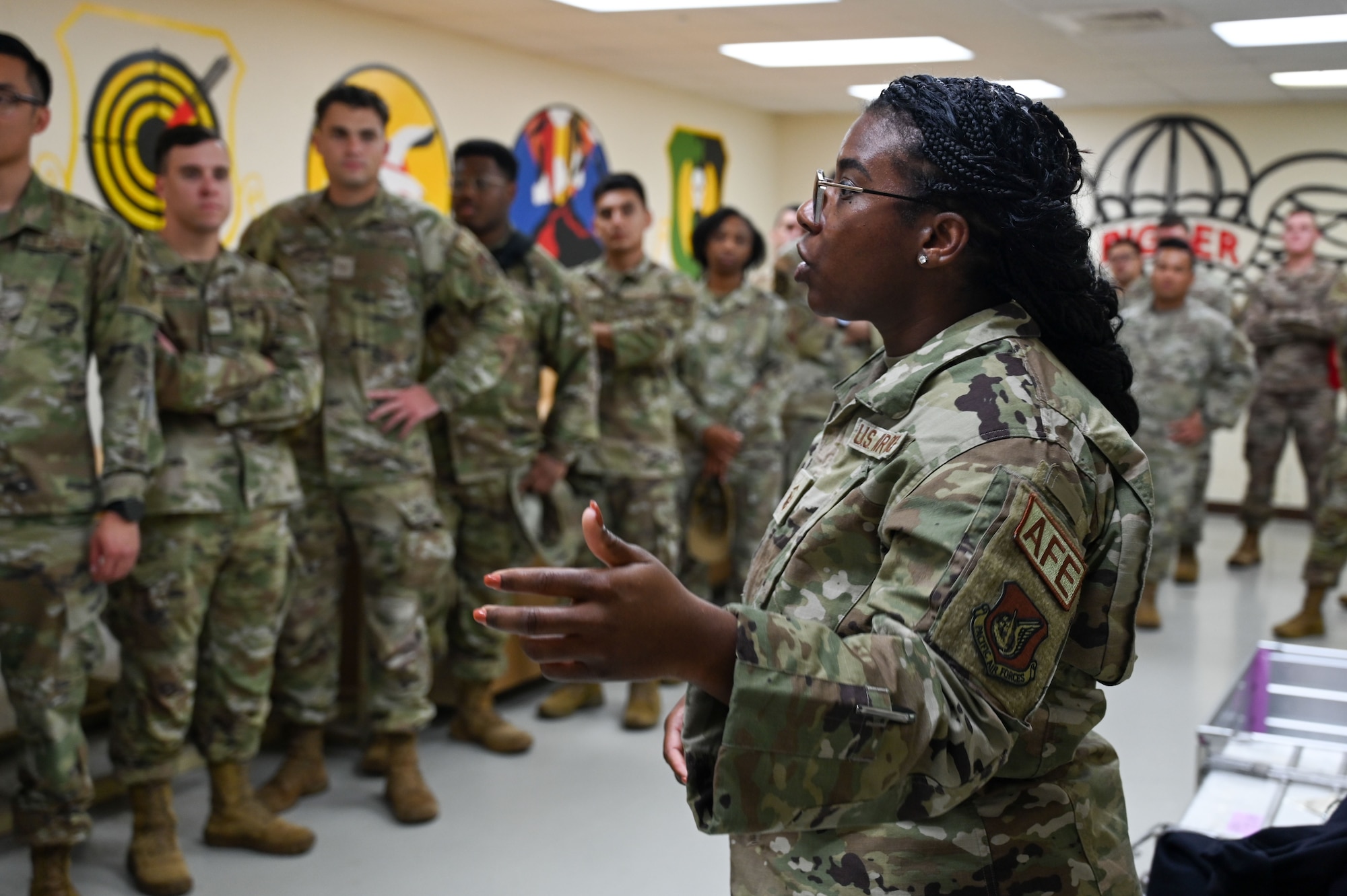 U.S. Air Force Master Sgt Fatiha Ford, superintendent, Aircrew Flight Equipment, 36th Operations Support Squadron (OSS), speaks to Airman Leadership School students on Andersen Air Force Base, Guam, Jan. 31, 2025. Ford led the Airmen on a tour of multiple OSS locations to include the air traffic control tower and a parachute drying facility. (U.S. Air Force photo by Airman 1st Class Natasha Ninete).