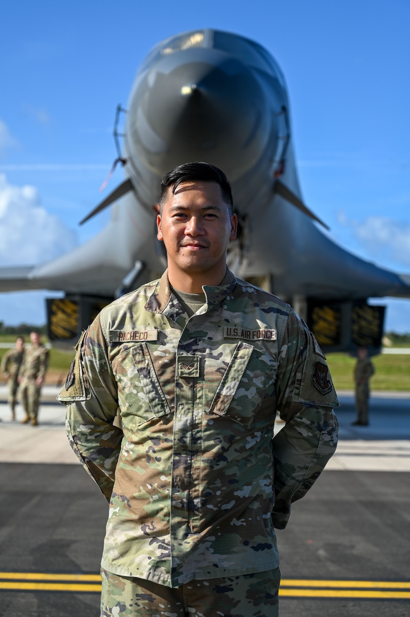 U.S. Air Force Senior Airman Michael Joel Pacheco, commander’s support staff, 624th Regional Support Group Operating Location-Alpha, poses in front of a B-1 Lancer on Andersen Air Force Base, Guam, Jan. 31, 2025. Pacheco and his graduating class received a comprehensive tour of the aircraft as part of a 36th Operations Group facilities tour. (U.S. Air Force photo by Airman 1st Class Natasha Ninete).