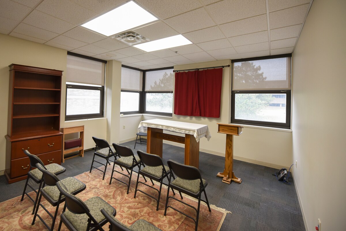A set of chairs face a podium inside the AFIT building