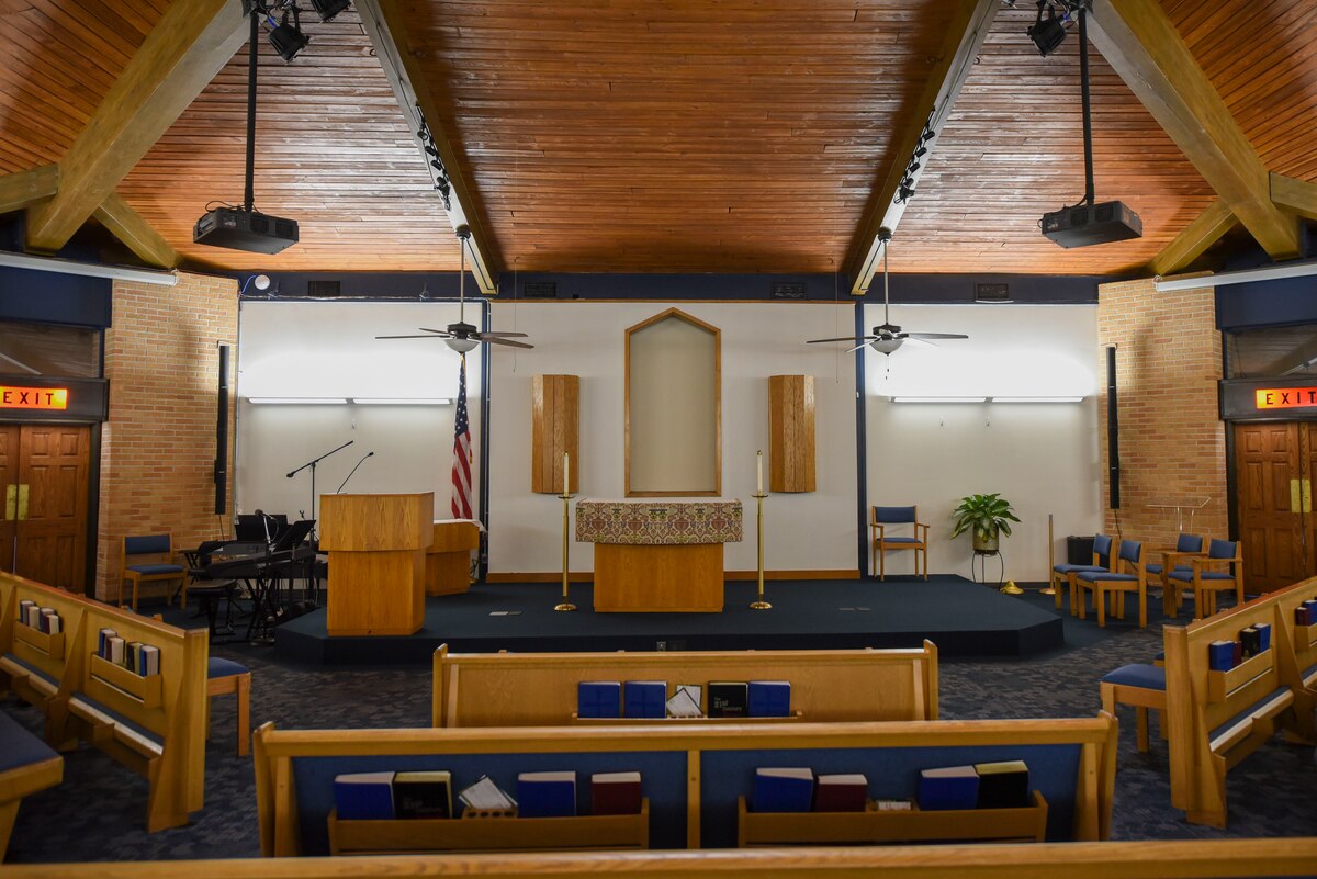 Pews facing the front podium of the Prairies Chapel