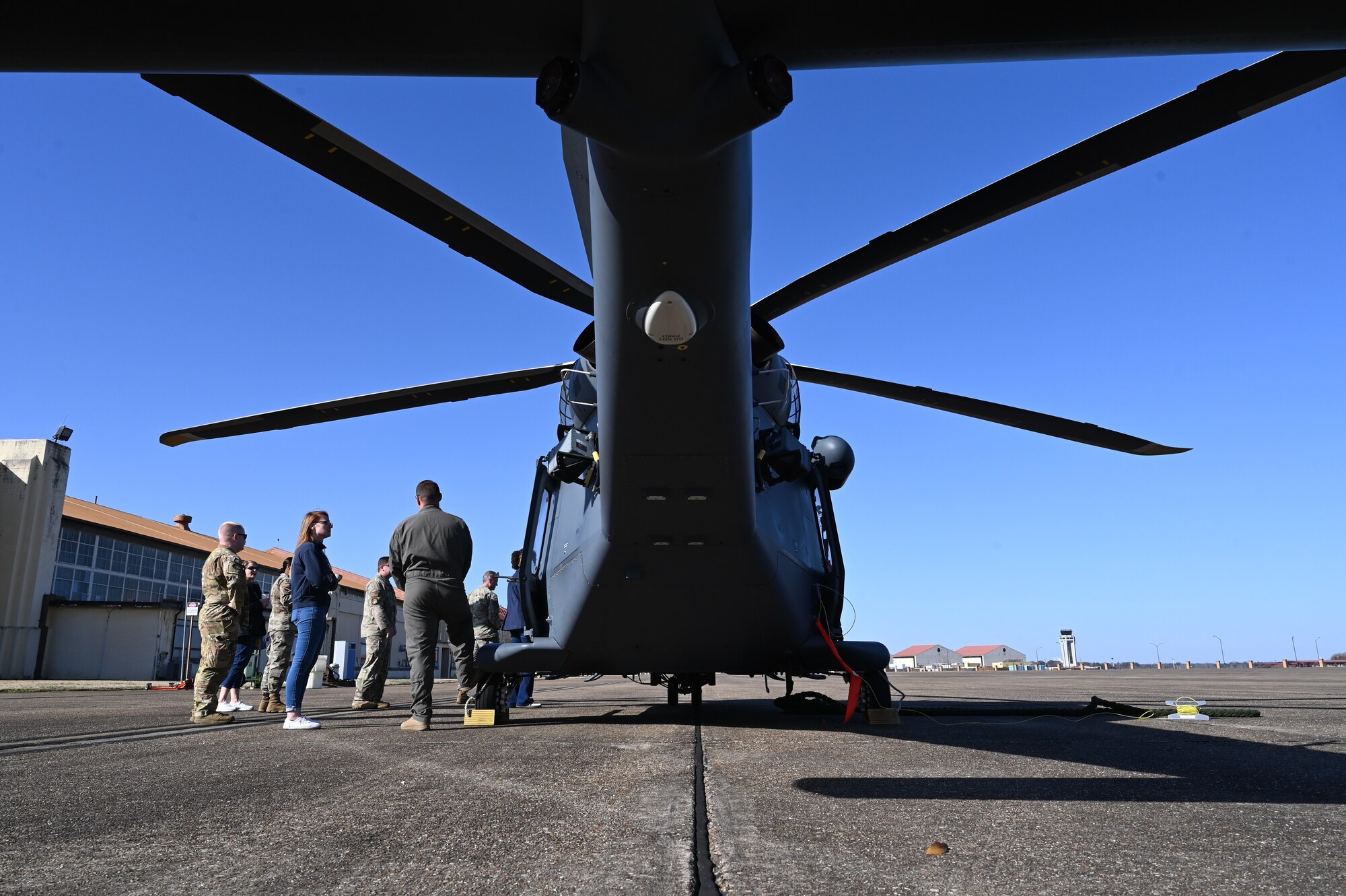 people talk near a helicopter