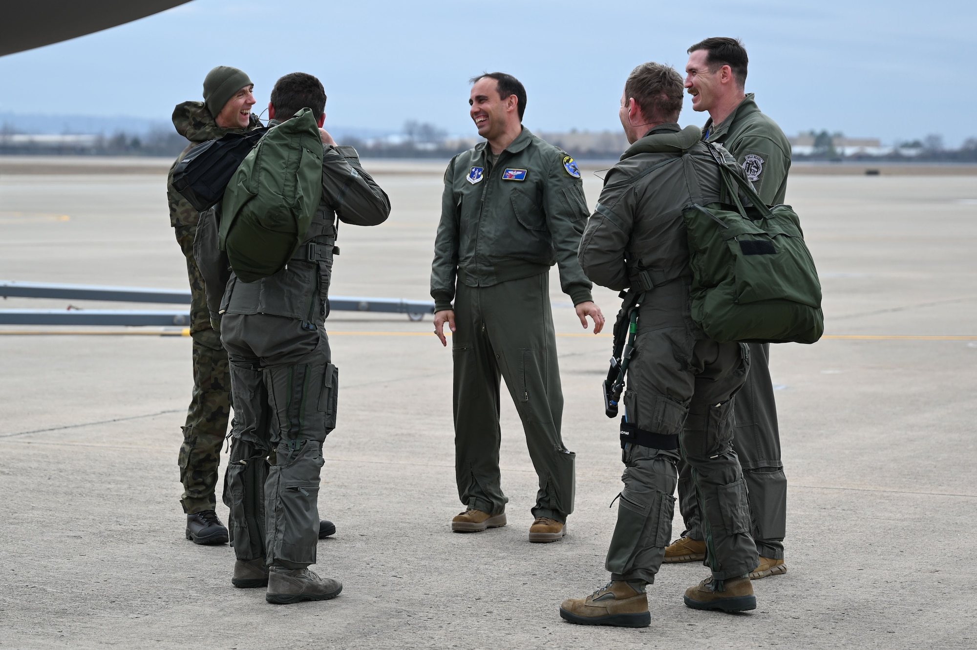 Polish F-35A Lightning II pilots and U.S. Air Force Instructor Pilots converse after executing ground ops for the first time at Ebbing Air National Guard Base, Arkansas, Jan. 29, 2025.