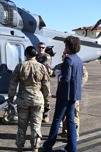 people talk near a helicopter