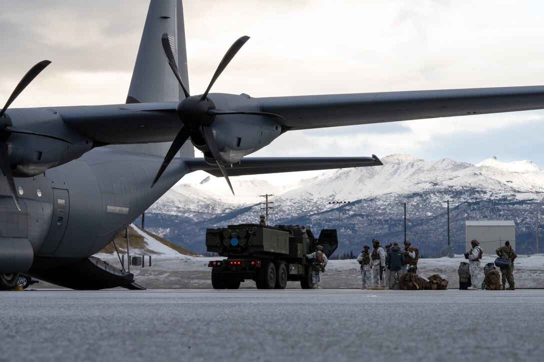 U.S. Marines from the 1st Marine Division prepare a M142 High Mobility Artillery Rocket System to load onto a C-130J Super Hercules during the Joint Pacific Multinational Readiness Center 25-02 training exercise at Joint Base Elmendorf-Richardson, Alaska, Jan. 19, 2025. JPMRC 25-02 provided the opportunity for the U.S. Air Force and U.S. Marine Corps to strengthen their skill sets together and accomplish the Department of Defense’s mission to provide combat-credible military forces. (U.S. Air Force Photo by Airman 1st Class Jade M. Caldwell)