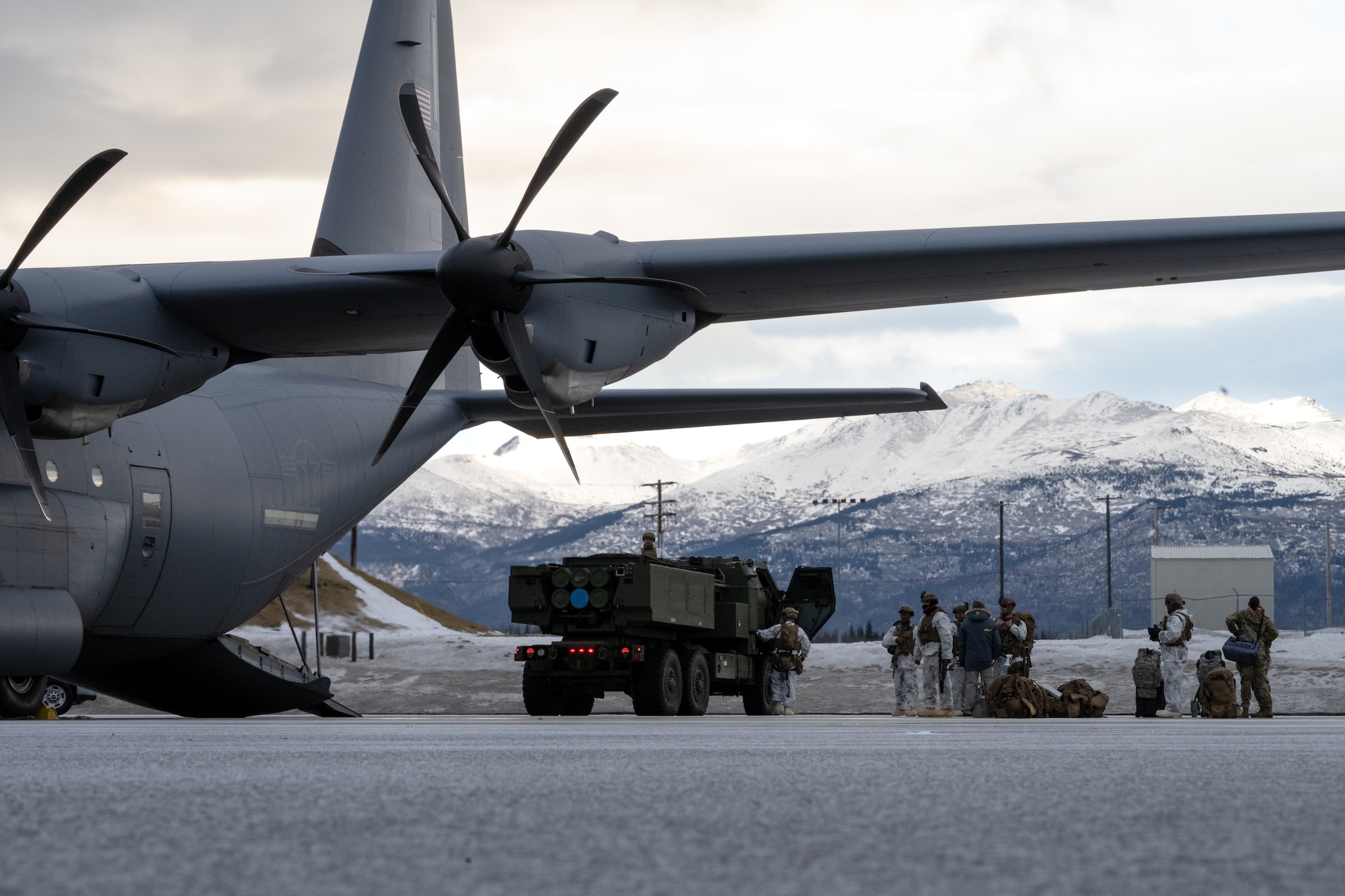 U.S. Marines from the 1st Marine Division prepare a M142 High Mobility Artillery Rocket System to load onto a C-130J Super Hercules during the Joint Pacific Multinational Readiness Center 25-02 training exercise at Joint Base Elmendorf-Richardson, Alaska, Jan. 19, 2025. JPMRC 25-02 provided the opportunity for the U.S. Air Force and U.S. Marine Corps to strengthen their skill sets together and accomplish the Department of Defense’s mission to provide combat-credible military forces. (U.S. Air Force Photo by Airman 1st Class Jade M. Caldwell)