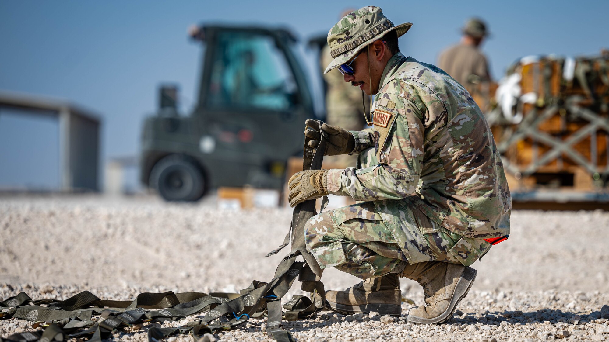 Airman prepares cargo straps.