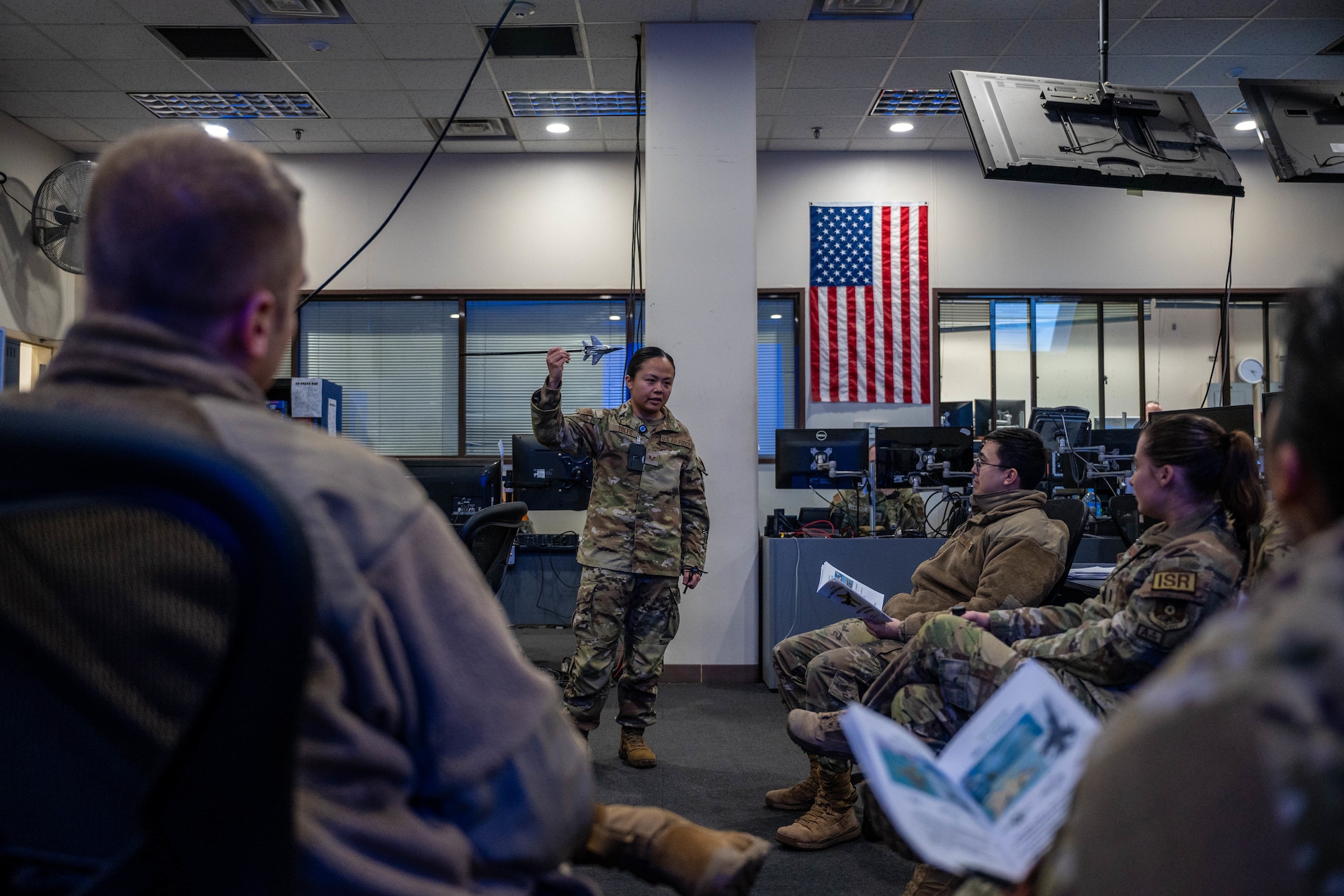 U.S. Air Force Staff Sgt. Hanna Tolfo, 54th Operations Support Squadron Intelligence Formal Training Unit instructor, center, speaks to a class during an F-16 IFTU session at Osan Air Base, Republic of Korea, Jan. 17, 2025. The student body for this course included a mix of ranks from officers to enlisted personnel. (U.S. Air Force photo by Staff Sgt. Christopher Tam)