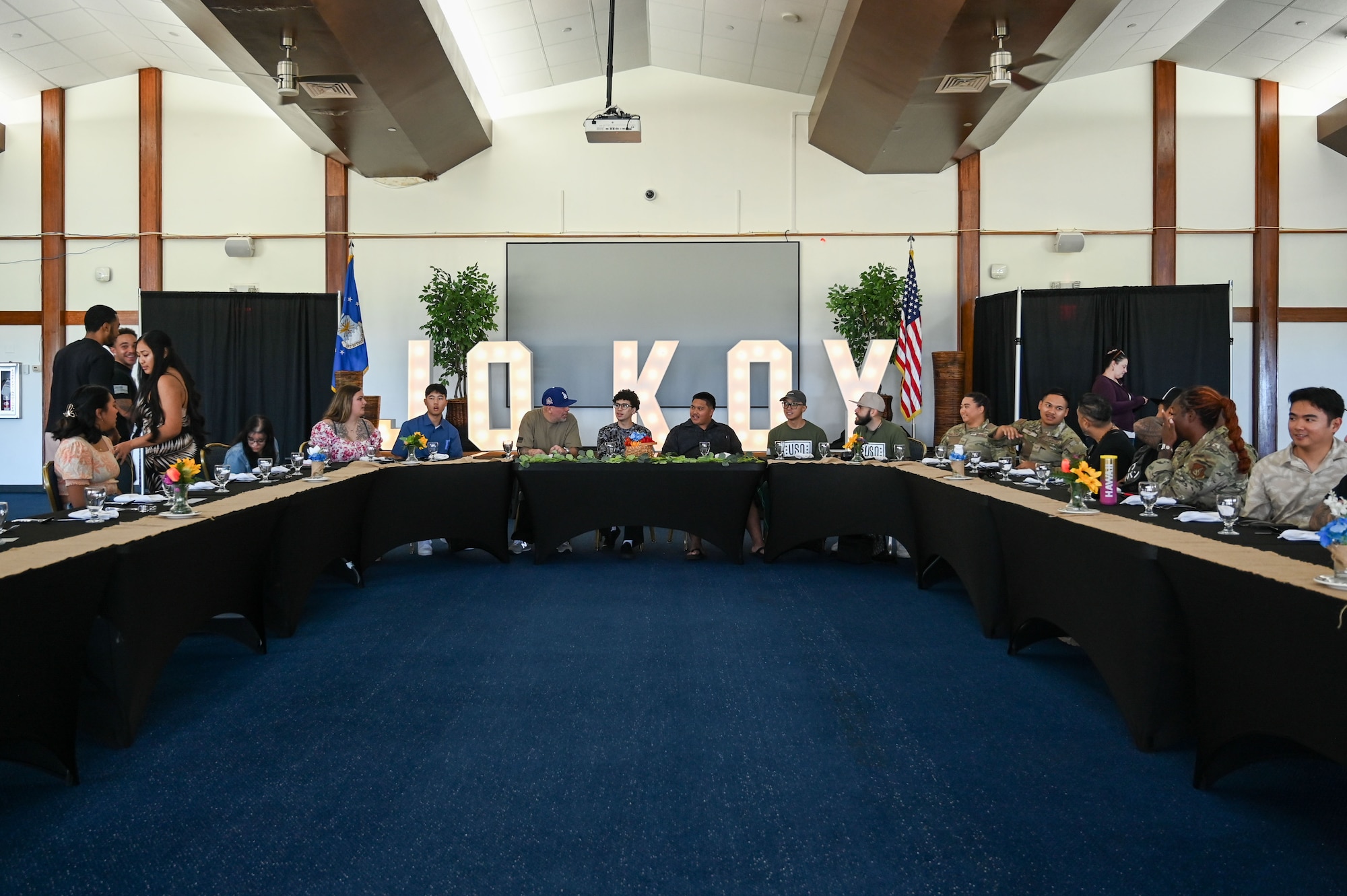 American comedian and actor, Jo Koy, and his team sit amongst Airmen at the Sunrise Conference Center on Andersen Air Force Base, Guam, Feb. 1, 2025. Jo Koy had lunch, toured the 736th Security Forces Squadron and performed a show for military service members as part of his USO comedy tour. (U.S. Air Force photo by Airman 1st Class Natasha Ninete).