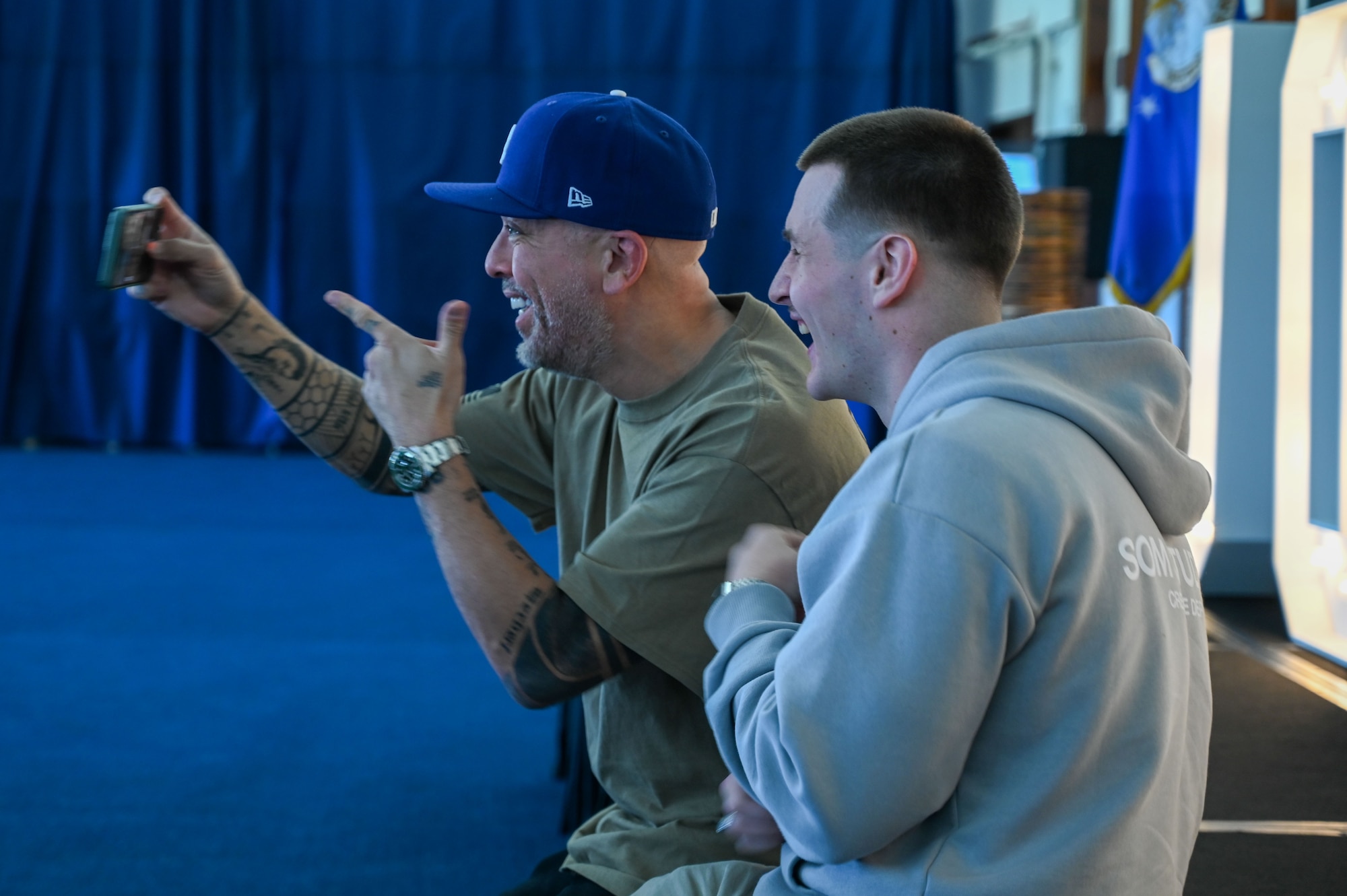 A U.S. Air Force Airman poses for a picture with American comedian and actor, Jo Koy, at the Sunrise Conference Center at Andersen Air Force Base, Guam, Feb. 1, 2025. Jo Koy visited the island as part of his USO comedy tour performing for military service members stationed in Japan and Guam. (U.S. Air Force photo by Airman 1st Class Natasha Ninete).