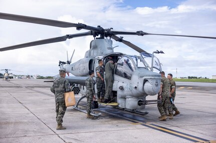 military members observe military helicopter