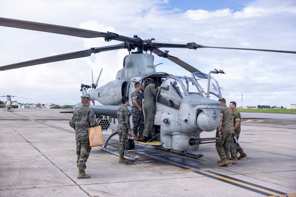 military members observe military helicopter
