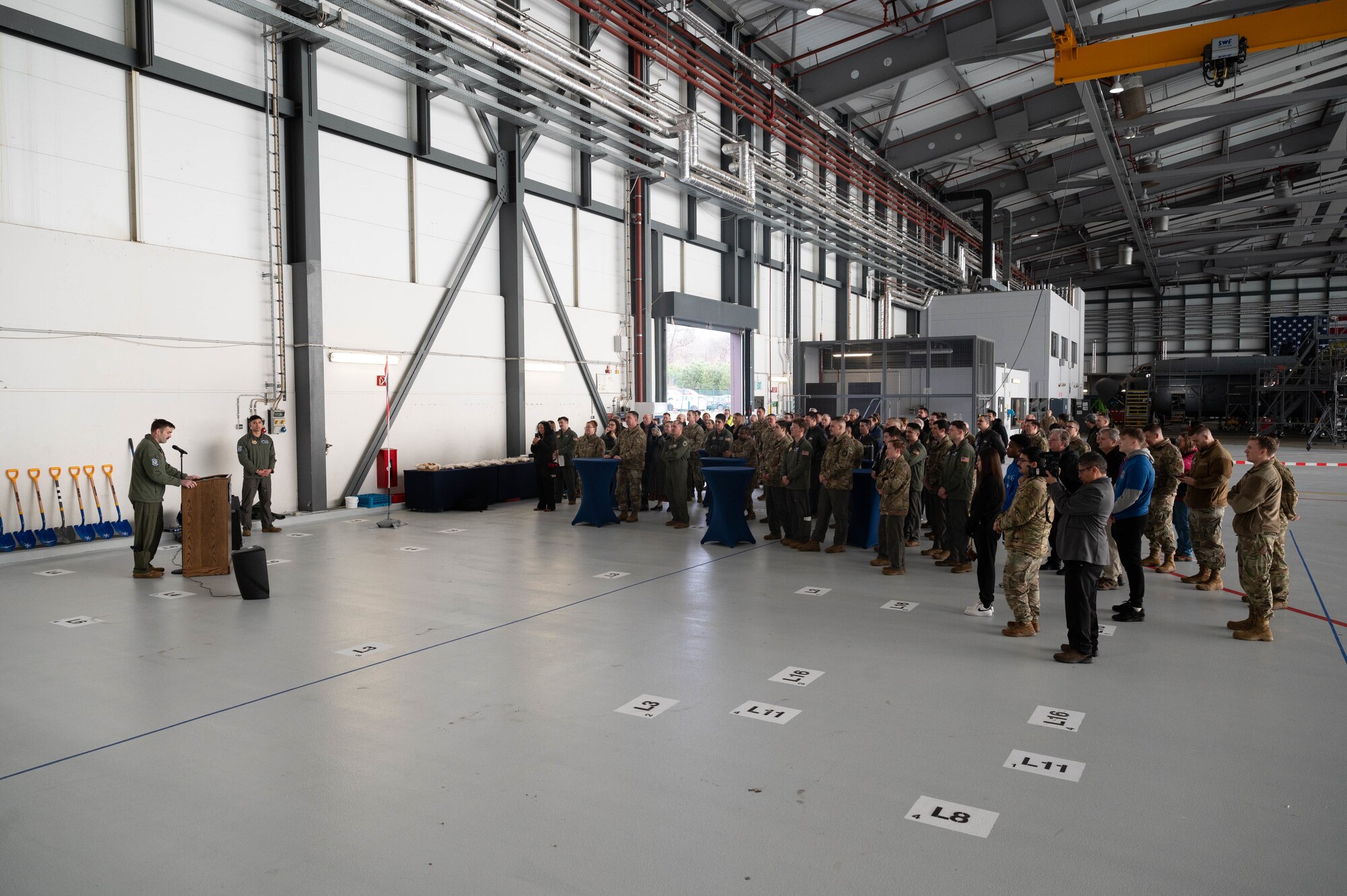 U.S. service members and local nationals celebrate the 37th Airlift Squadron groundbreaking ceremony of the installation of a new operations center at Ramstein Air Base