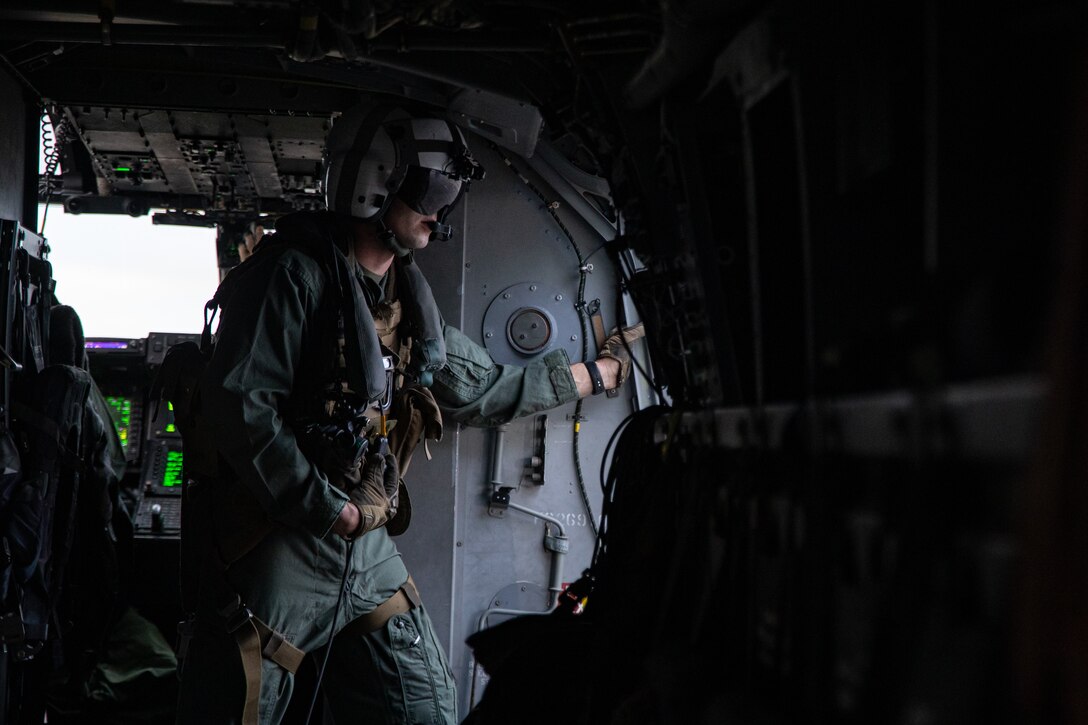 U.S. Marine Corps Gunnery Sgt. Gary Fleck, tiltrotor airframe mechanic with Marine Medium Tiltrotor Squadron (VMM) 774, Marine Aircraft Group 49, 4th Marine Aircraft Wing, helps guide a MV-22 Osprey, tiltrotor aircraft, on Naval Air Station Joint Reserve Base New Orleans, Belle Chasse, Louisiana, Feb. 4, 2025. MV-22 Osprey pilots and flight crew with VMM-744, Marine Aircraft Group 49, 4th Marine Aircraft Wing and VMM-764, Marine Aircraft Group 41, 4th Marine Aircraft Wing conducted a flight rehearsal in preparation for the flyover during Super Bowl LIX. (U.S. Marine Corps photo by Lance Cpl. Van Hoang)