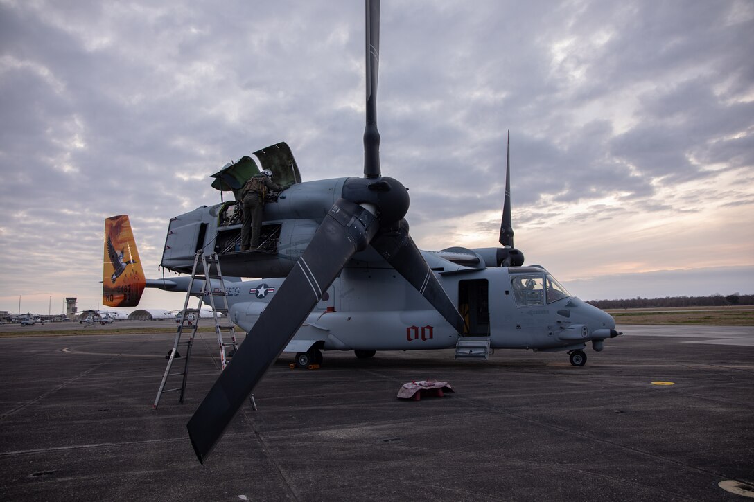 A U.S. Marine Corps crew chief with Marine Medium Tiltrotor Squadron (VMM) 774, Marine Aircraft Group 49, 4th Marine Aircraft Wing, inspects an MV-22 Osprey, tiltrotor aircraft, before a rehearsal flight, Naval Air Station Joint Reserve Base New Orleans, Belle Chasse, Louisiana, Feb. 4, 2025. The rehearsal flight was conducted in preparation for a flyover during Super Bowl LIX. (U.S. Marine Corps photo by Lance Cpl. Van Hoang)