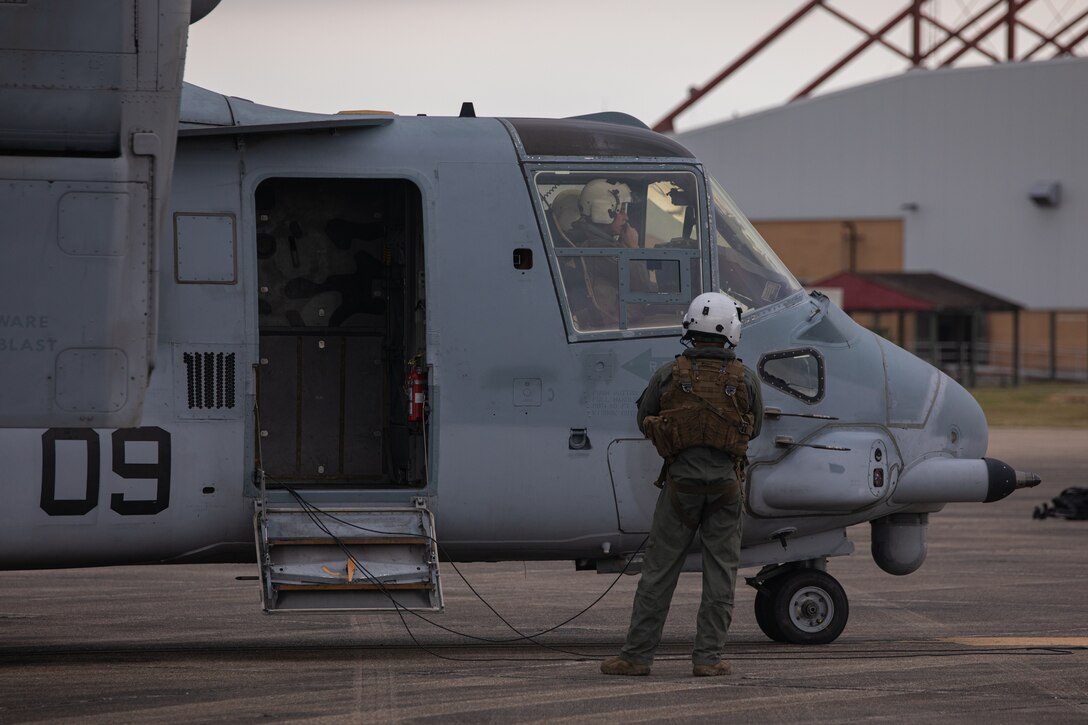 A U.S. Marine Corps crew chief with Marine Medium Tiltrotor Squadron (VMM) 774, Marine Aircraft Group 49, 4th Marine Aircraft Wing, inspects an MV-22 Osprey, tiltrotor aircraft, before a rehearsal flight, Naval Air Station Joint Reserve Base New Orleans, Belle Chasse, Louisiana, Feb. 4, 2025. The rehearsal flight was conducted in preparation for a flyover during Super Bowl LIX. (U.S. Marine Corps photo by Lance Cpl. Van Hoang)