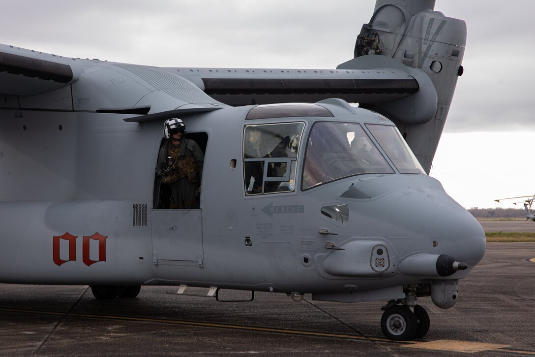 U.S. Marine Corps Gunnery Sgt. Gary Fleck, tiltrotor airframe mechanic with Marine Medium Tiltrotor Squadron (VMM) 774, Marine Aircraft Group 49, 4th Marine Aircraft Wing, helps guide an MV-22 Osprey, tiltrotor aircraft, to a runway on Naval Air Station Joint Reserve Base New Orleans, Belle Chasse, Louisiana, Feb. 4, 2025. MV-22 Osprey pilots and flight crew with VMM-744, Marine Aircraft Group 49, 4th Marine Aircraft Wing and VMM-764, Marine Aircraft Group 41, 4th Marine Aircraft Wing conducted a flight rehearsal in preparation for the flyover during Super Bowl LIX. (U.S. Marine Corps photo by Lance Cpl. Van Hoang)