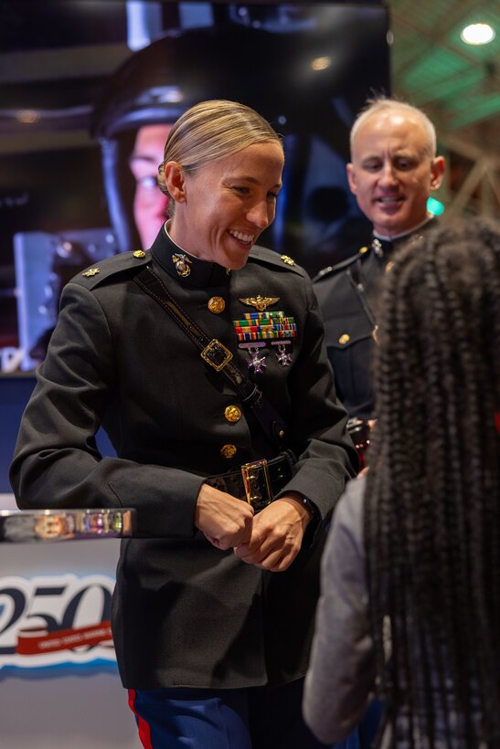 U.S. Marine Corps Maj. Jenna Montgomery, MV-22 Osprey pilot, Marine Medium Tiltrotor Squadron (VMM) 774, 4th Marine Aircraft Wing, interacts with attendees during the NFL’s Super Bowl Fan Zone Experience at the Ernest N. Morial Convention Center, New Orleans, Feb. 5, 2025. Marines from Marine Medium Tiltrotor Squadron (VMM) 774 and 764 participated in the experience, giving them the opportunity to interact with the American public, increase knowledge about the Marine Corps Reserve and kickoff the celebration of the U.S. Marine Corps’ 250th birthday. (U.S. Marine Corps Photo by Lance Cpl. Juan Diaz)