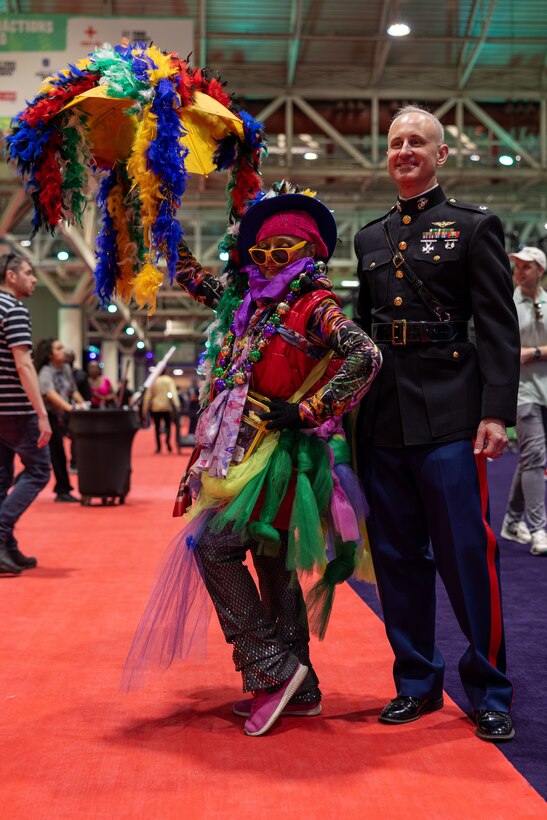 U.S. Marine Corps Lt. Col Sean Houlsey, commanding officer, Marine Medium Tiltrotor Squadron (VMM) 764, 4th Marine Aircraft Wing, poses for a photo with an attendee during the NFL’s Super Bowl Fan Zone Experience at the Ernest N. Morial Convention Center, New Orleans, Feb. 5, 2025. Marines from Marine Medium Tiltrotor Squadron (VMM) 774 and 764 participated in the experience, giving them the opportunity to interact with the American public, increase knowledge about the Marine Corps Reserve and kickoff the celebration of the U.S. Marine Corps’ 250th birthday. (U.S. Marine Corps Photo by Lance Cpl. Juan Diaz)