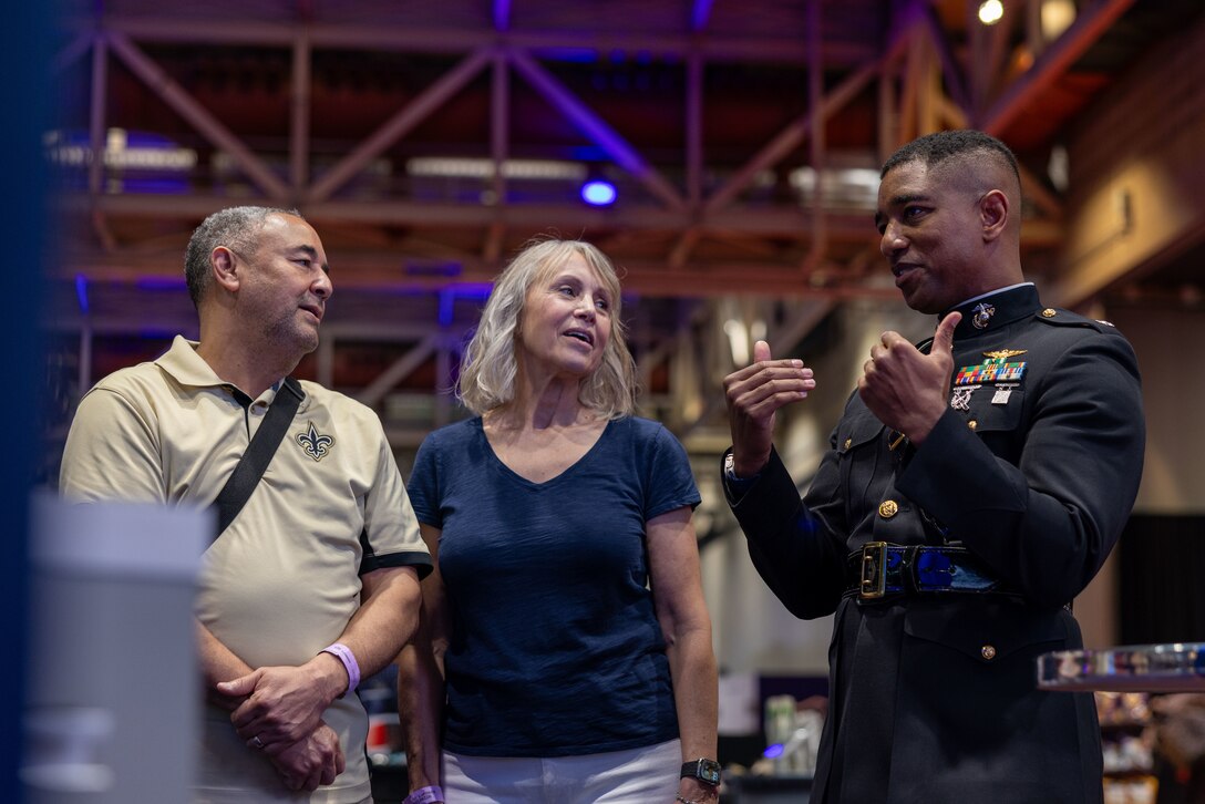 U.S. Marine Corps Lt. Col. Steven Dixon, executive officer, Marine Medium Tiltrotor Squadron (VMM) 764, 4th Marine Aircraft Wing, interacts with attendees during the NFL’s Super Bowl Fan Zone Experience at the Ernest N. Morial Convention Center, New Orleans, Feb. 5, 2025. Marines from Marine Medium Tiltrotor Squadron (VMM) 774 and 764 participated in the experience, giving them the opportunity to interact with the American public, increase knowledge about the Marine Corps Reserve and kickoff the celebration of the U.S. Marine Corps’ 250th birthday. (U.S. Marine Corps Photo by Lance Cpl. Juan Diaz)