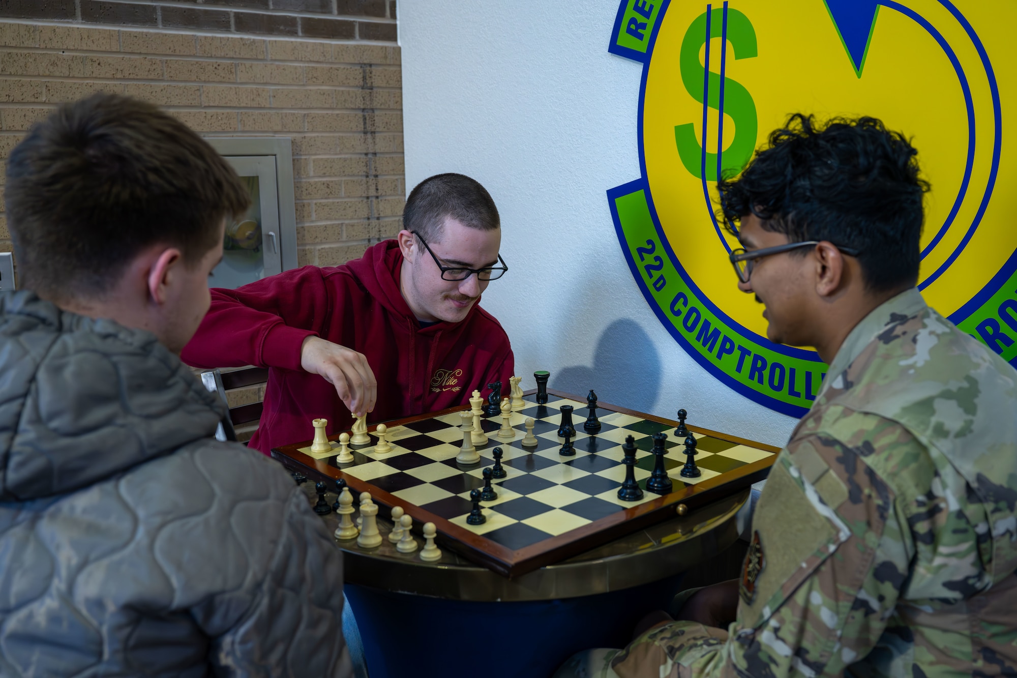 22nd Air Refueling Wing Airmen play chess in between Tanker Talk classes during Resiliency Day Feb. 3, 2025, at McConnell Air Force Base, Kansas. Civilian attire was approved to wear to promote a stress free and comfortable atmosphere allowing Airmen to focus on fostering resilience and well-being. (U.S. Air Force photo by Airman 1st Class Paula Arce)
