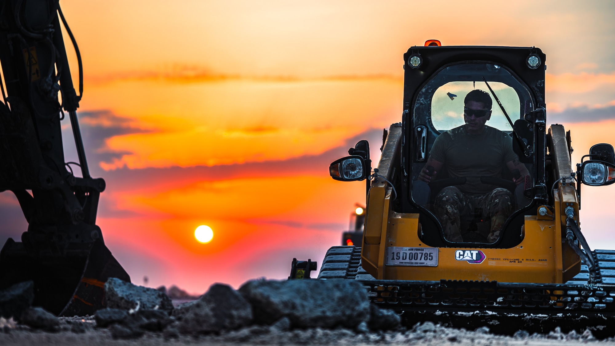 Airman moves debris
