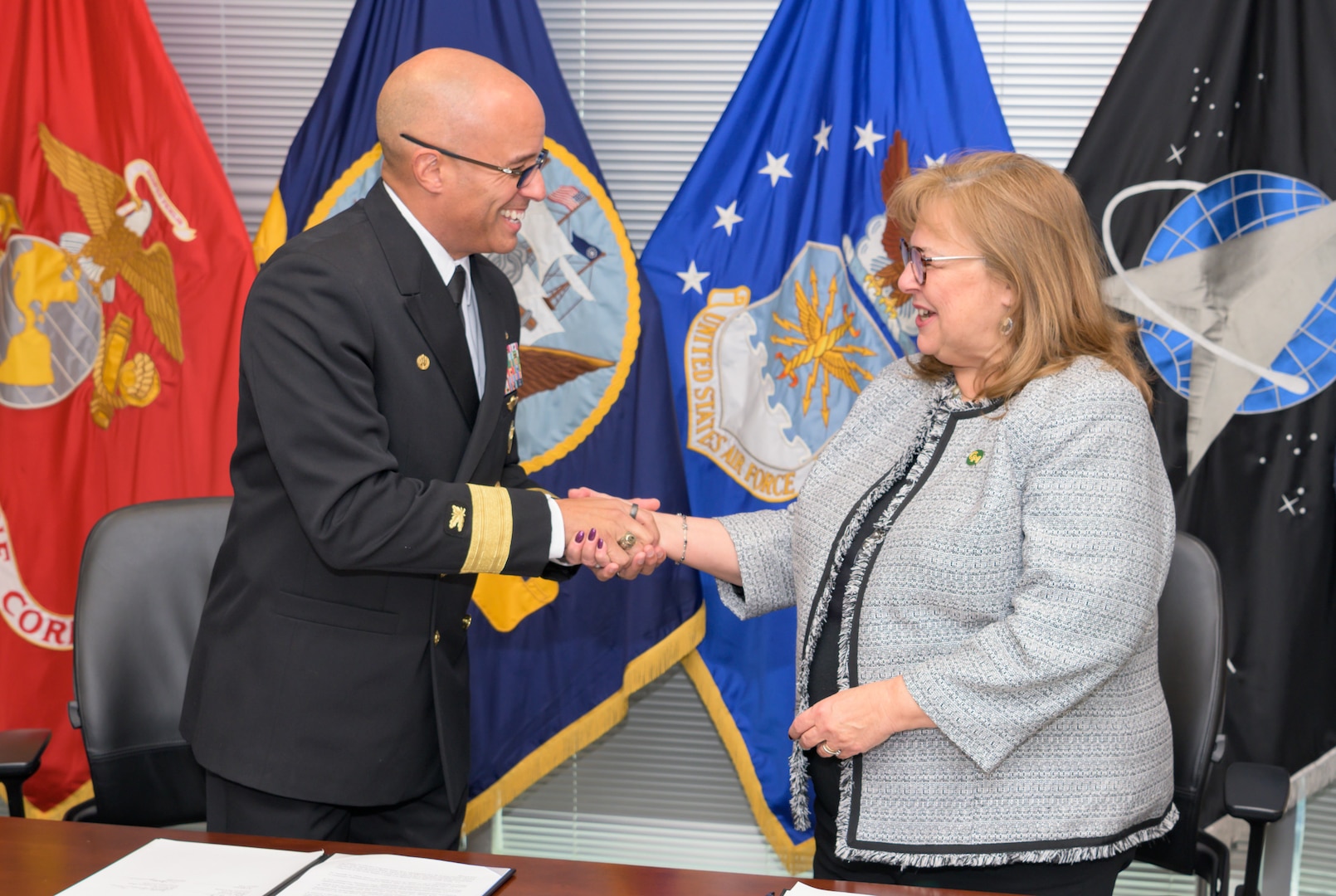 Defense Logistics Agency Energy Commander and George Mason’s Vice Provost for Academic Affairs congratulate one another after signing an updated Memorandum of Understanding.