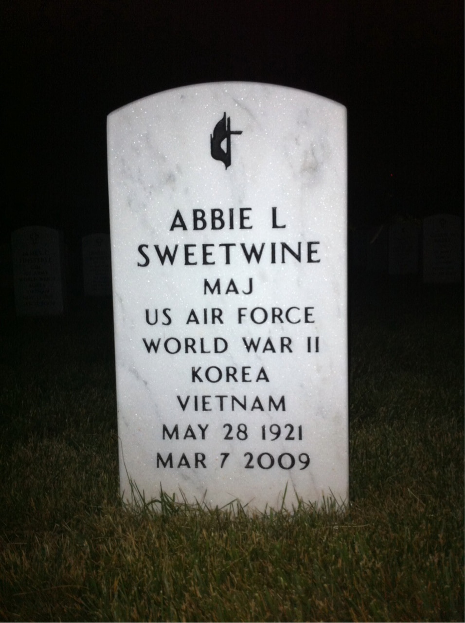 Abbie L Sweetwine's gravestone stands in the grass.