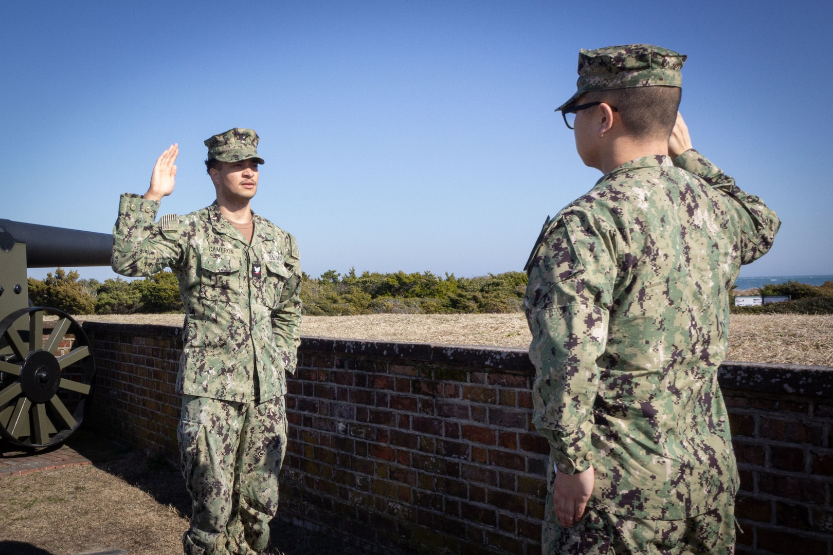 Hospital Corpsman Third Class Jeovony Cameron, left, reenlisted in the U.S. Navy during a ceremony conducted Tuesday, February 4, 2025 at Fort Macon State Park North Carolina.