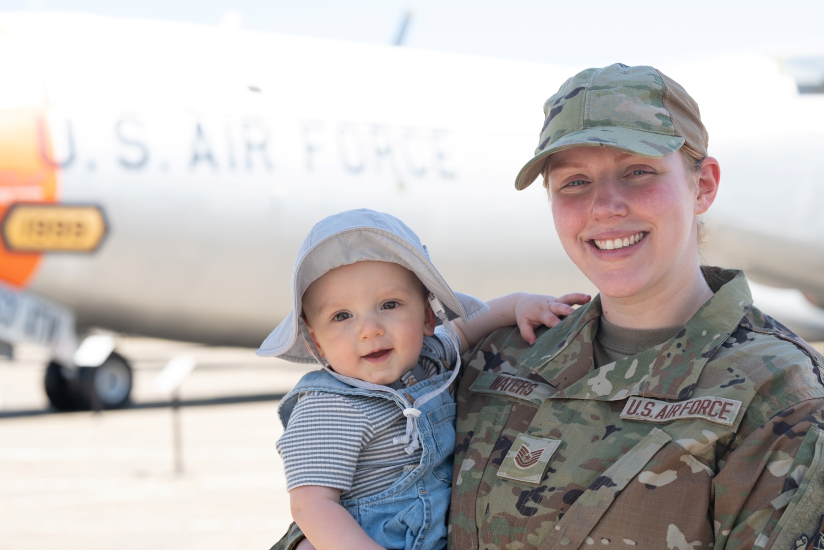 Woman smiles with a baby