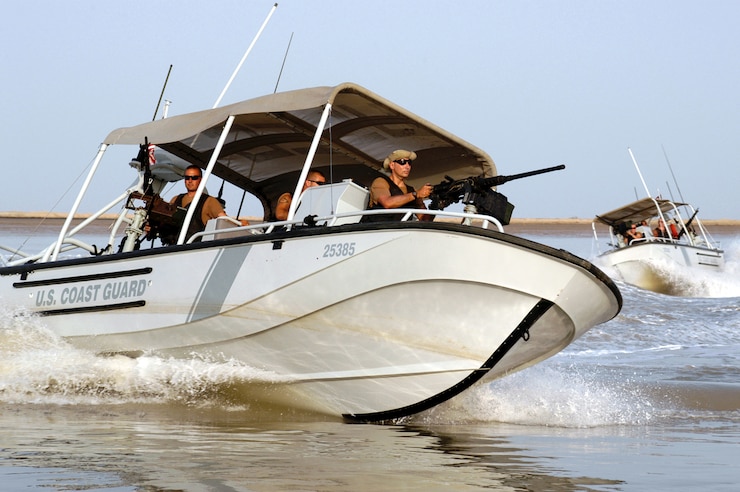 Two Coast Guard reserve boats going fast on the water.